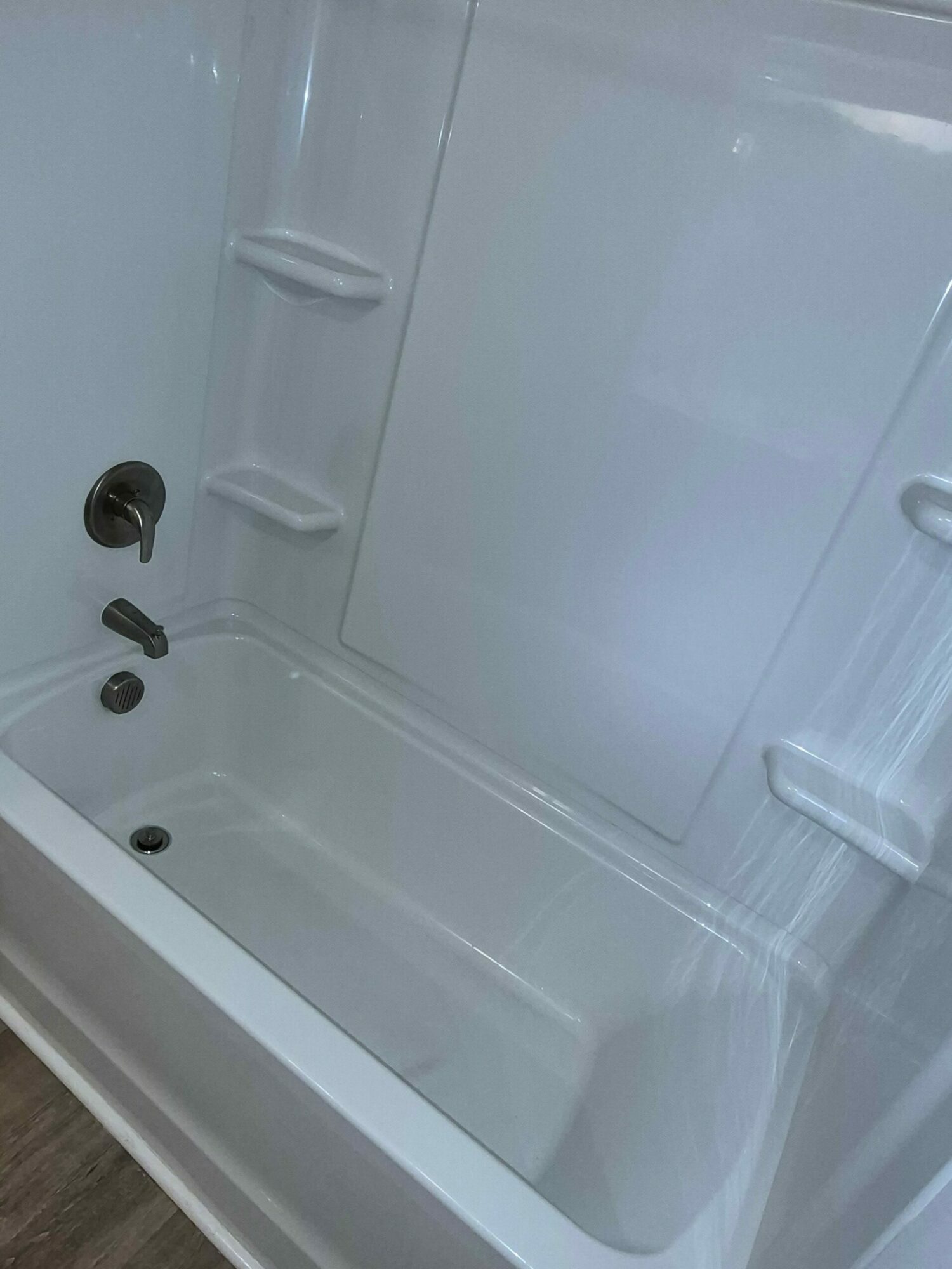 Empty white refrigerator interior with shelves and door compartments.