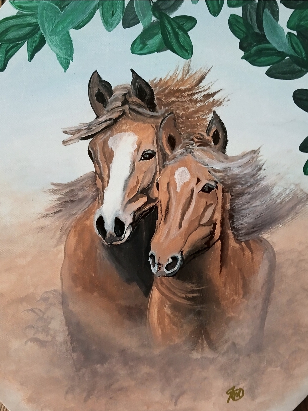 Two horses with flowing manes stand close together, surrounded by green leaves, in a natural setting.