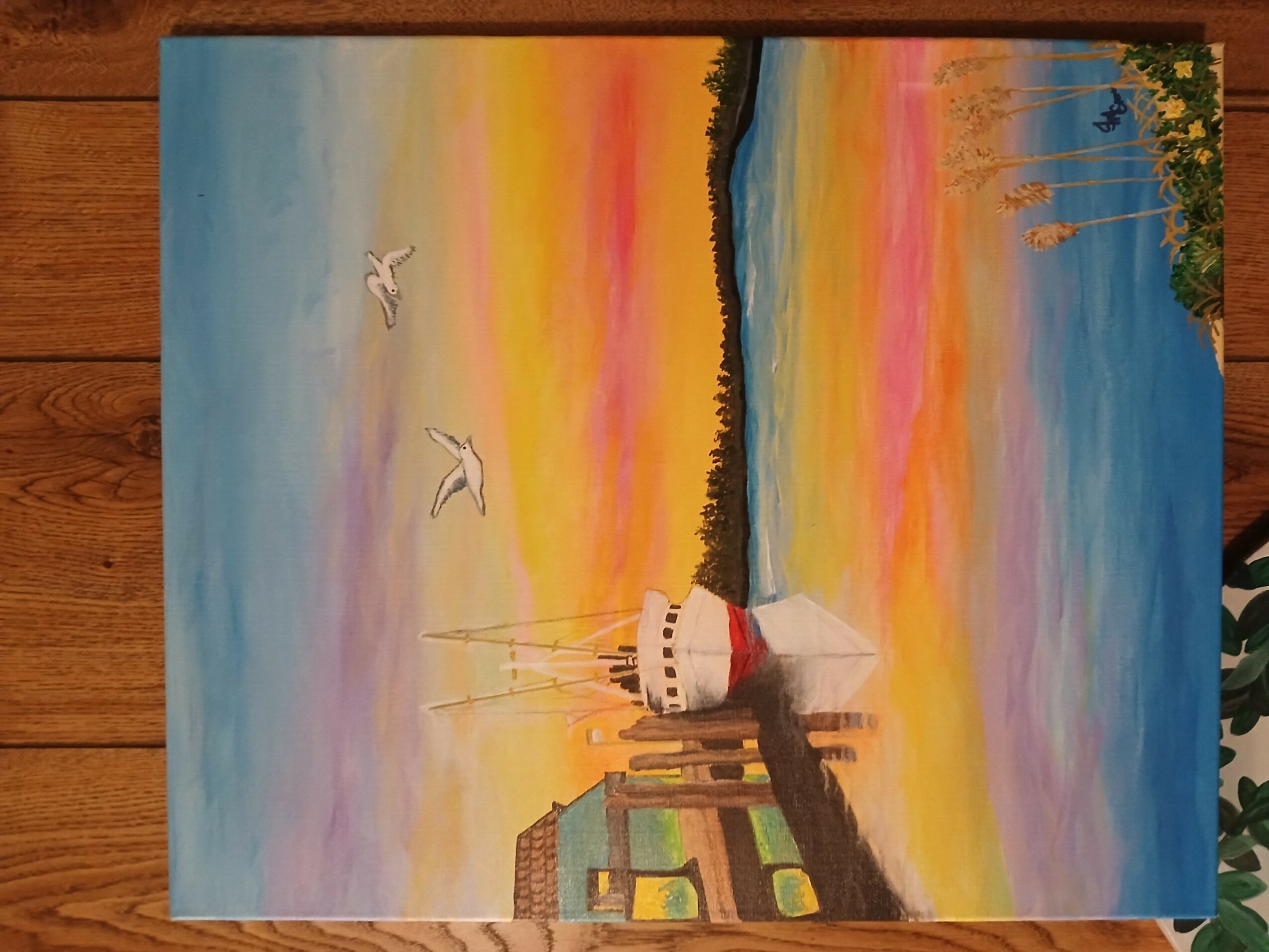 Painting of a lighthouse on a pier with colorful sunset sky and seagulls flying, water, and distant trees.