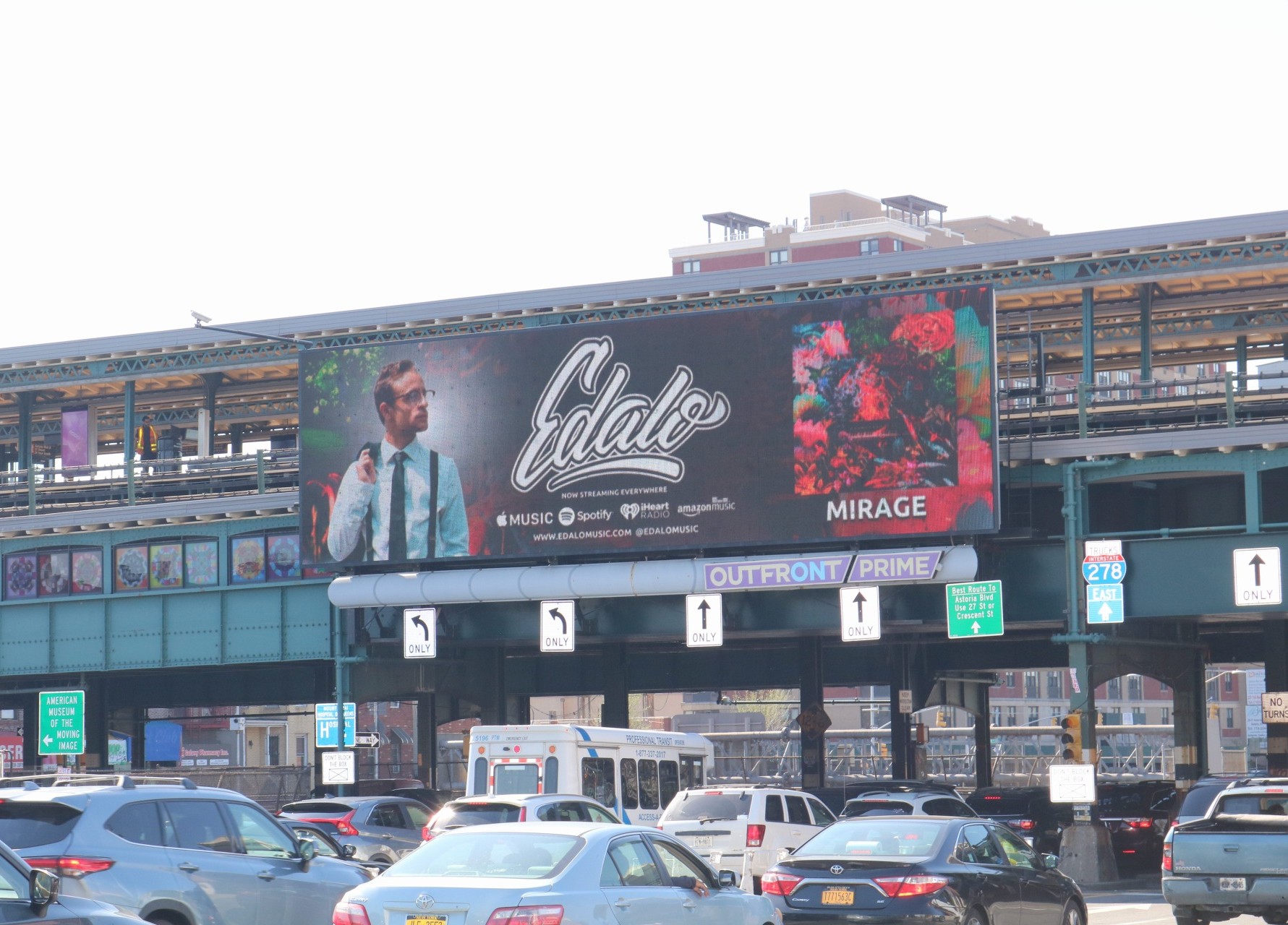 Billboard advertising a music artist named Cale with a photo of a man in a suit, and a floral image with the word 'MIRAGE'.