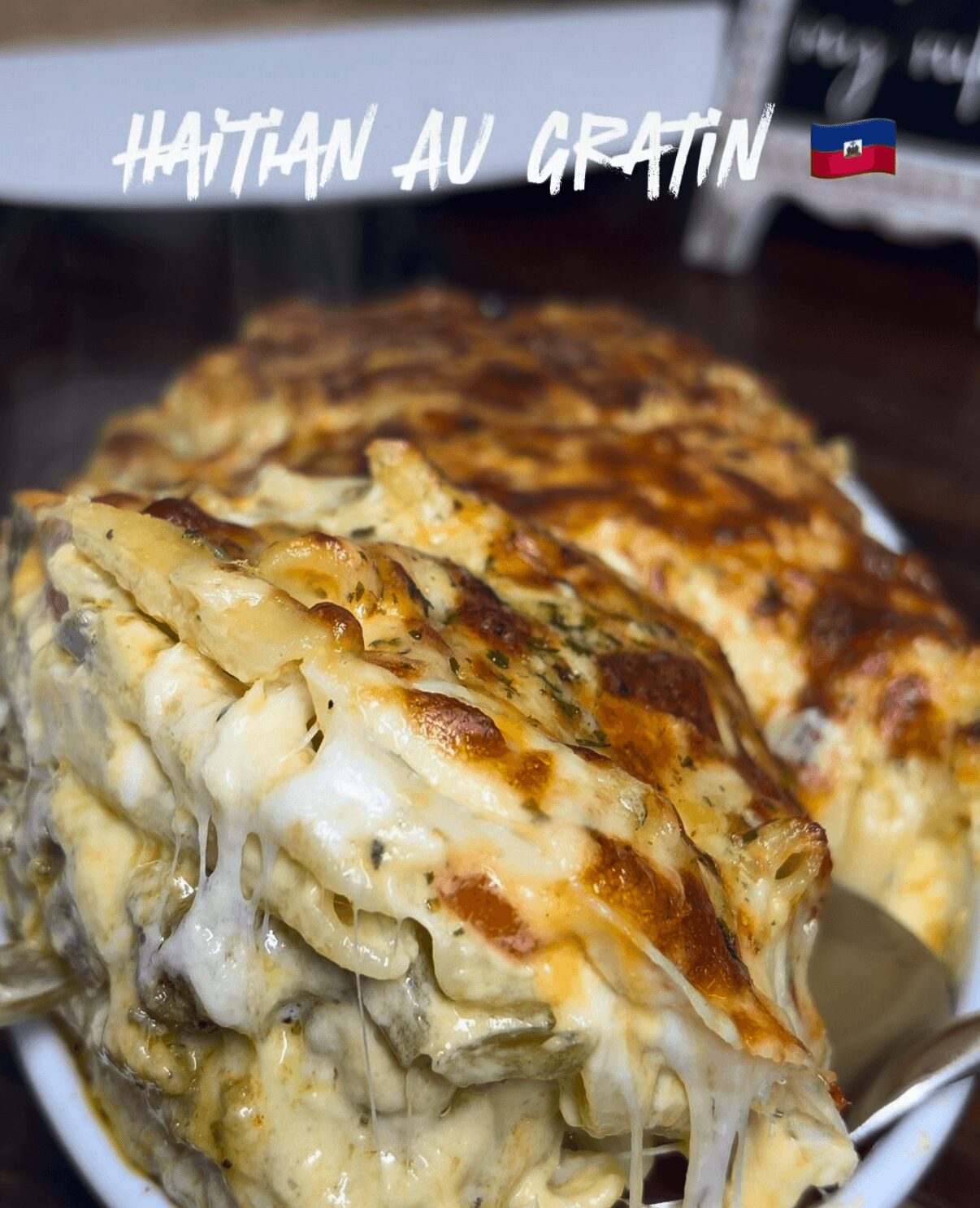 Close-up of Haitian Haitian au gratin dish with melted cheese and baked topping, served in a bowl.