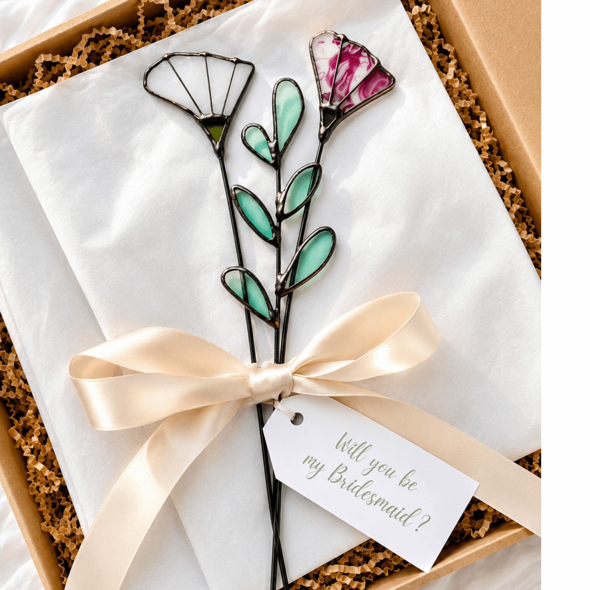 Wire flower with pink and purple glass petals, tied with a cream ribbon, in a gift box with a note asking,