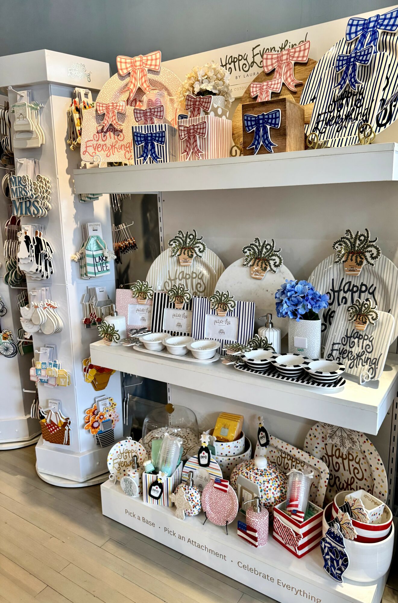 Shelves display decorative gift boxes, jars, and accessories with bows, flowers, and patterns, arranged on white shelves.