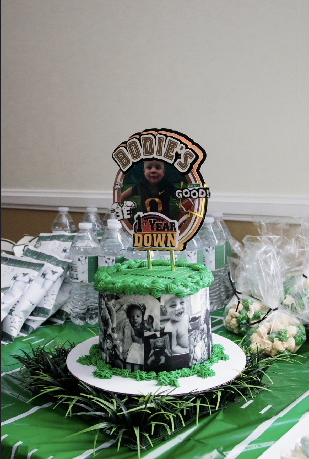 Cake with black-and-white photos, green frosting, and a topper reading 'DON'T WORRY BE GOOD, FEAR DOWN'.