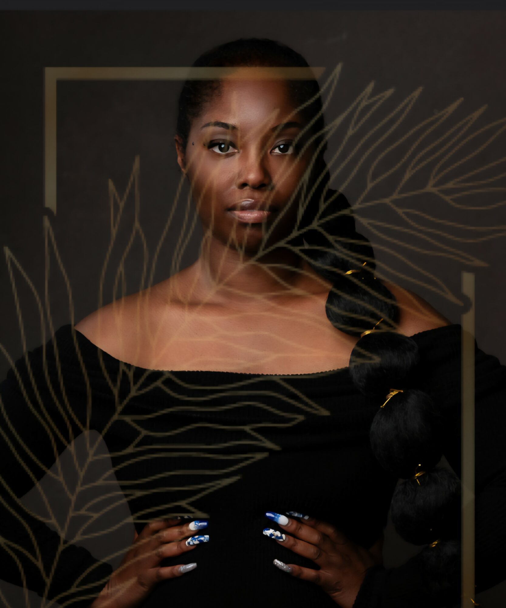 Portrait of a woman with dark hair and makeup, wearing a black top, hands on hips, with decorative leaf patterns overlay.