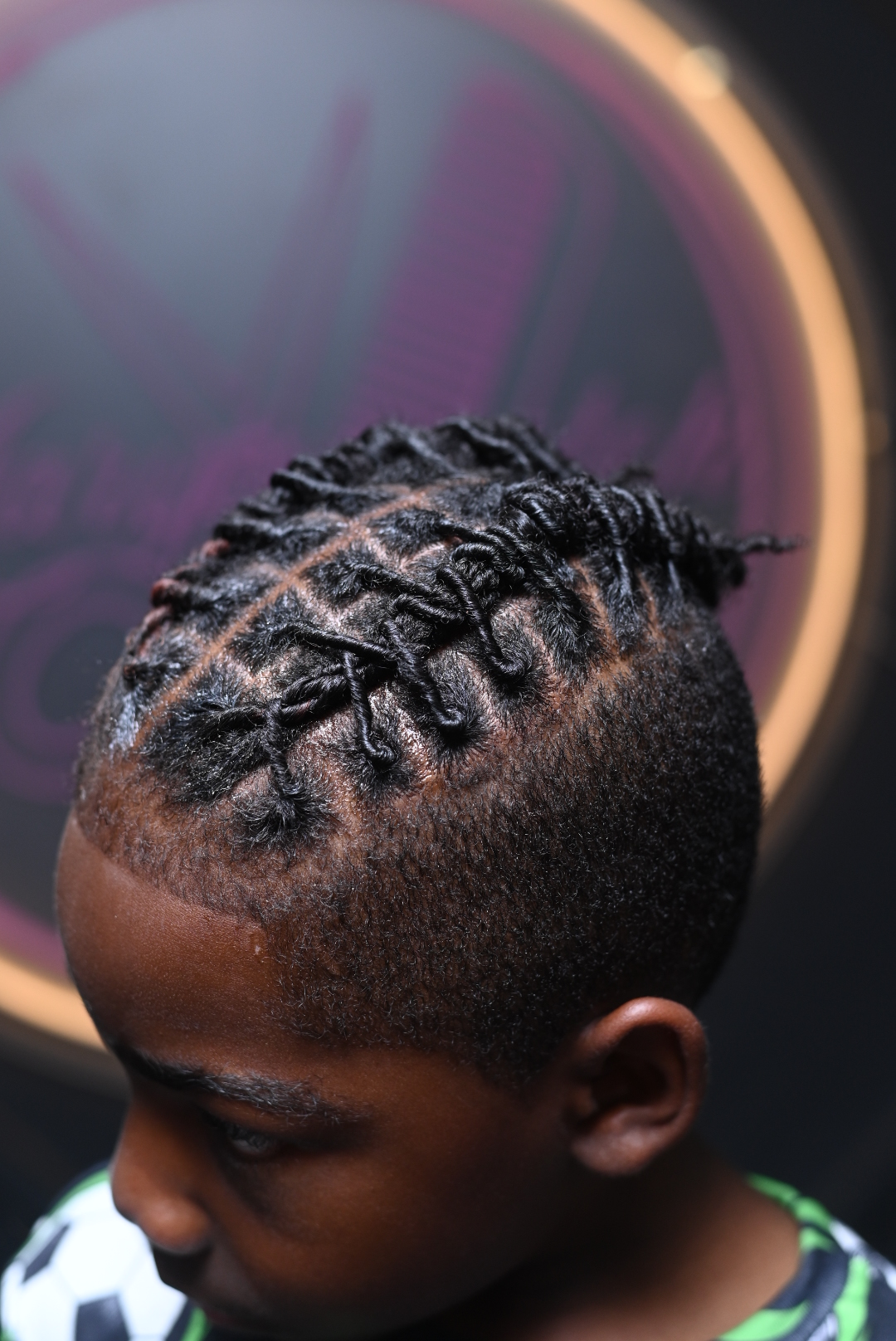 Top view of a person's head with braided hairstyle, showing the scalp and hair pattern.
