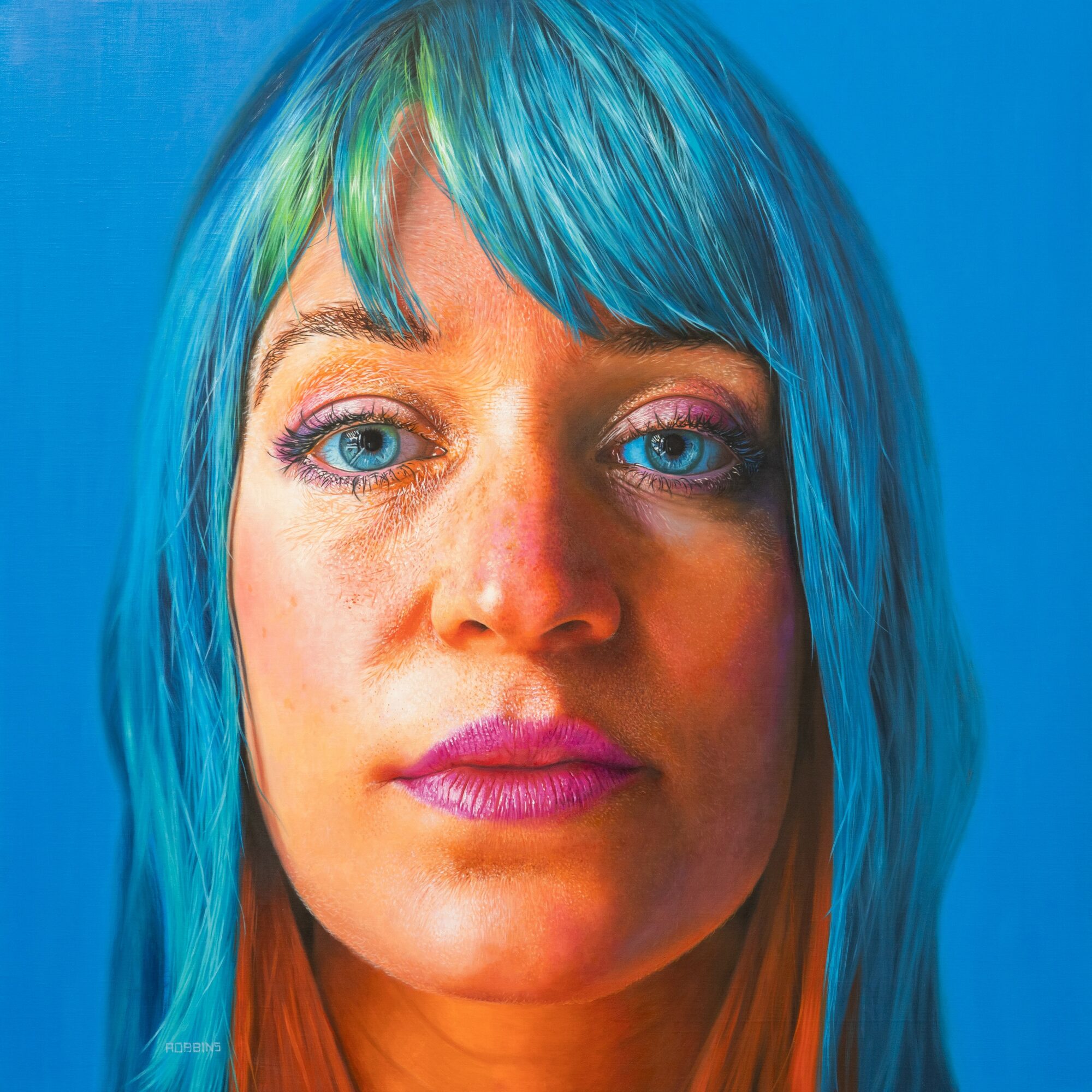 Close-up of a woman with blue and green hair, blue eyes, and pink lipstick against a blue background.