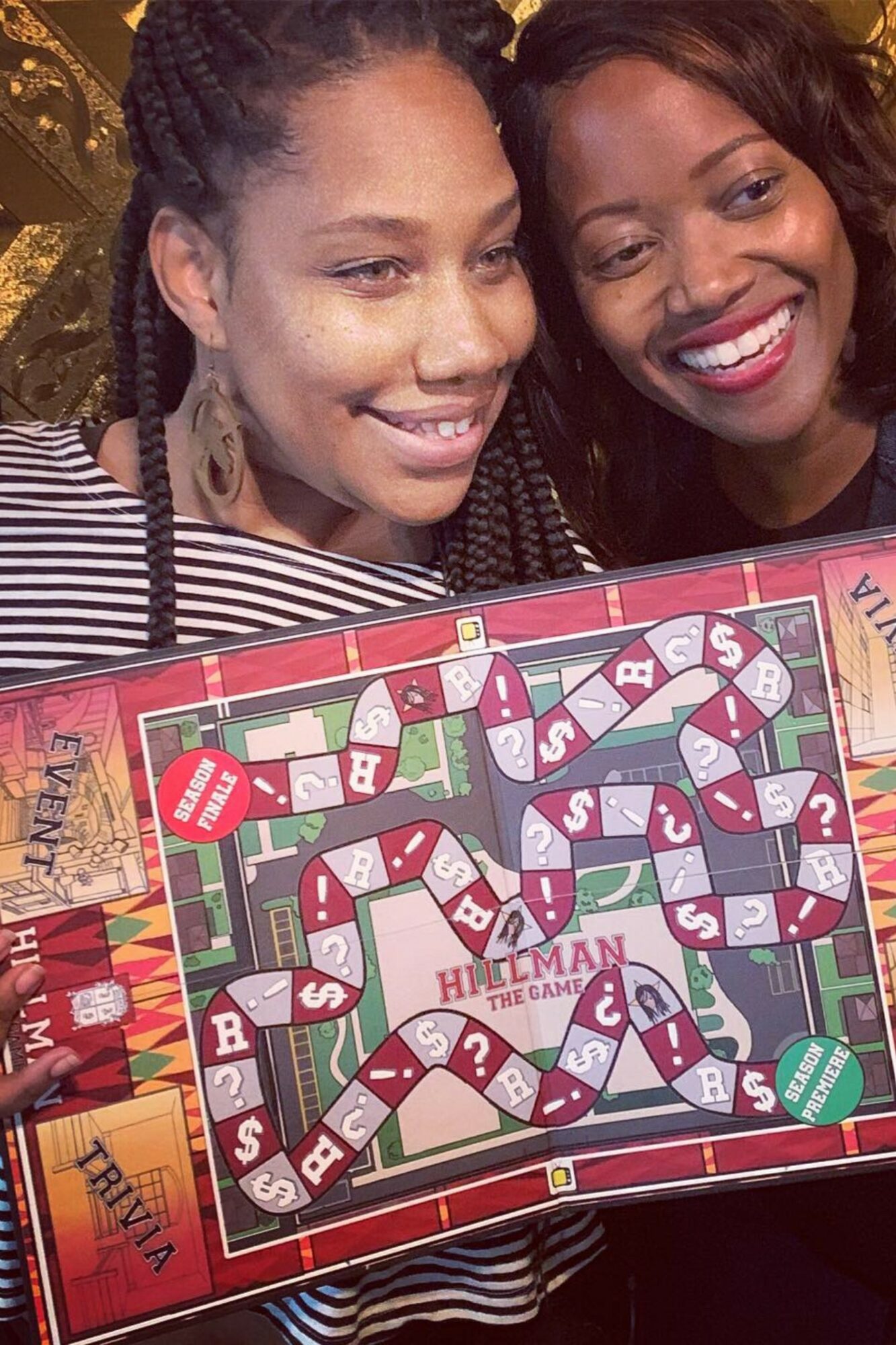 Two women smiling and playing a colorful board game together, close-up shot.